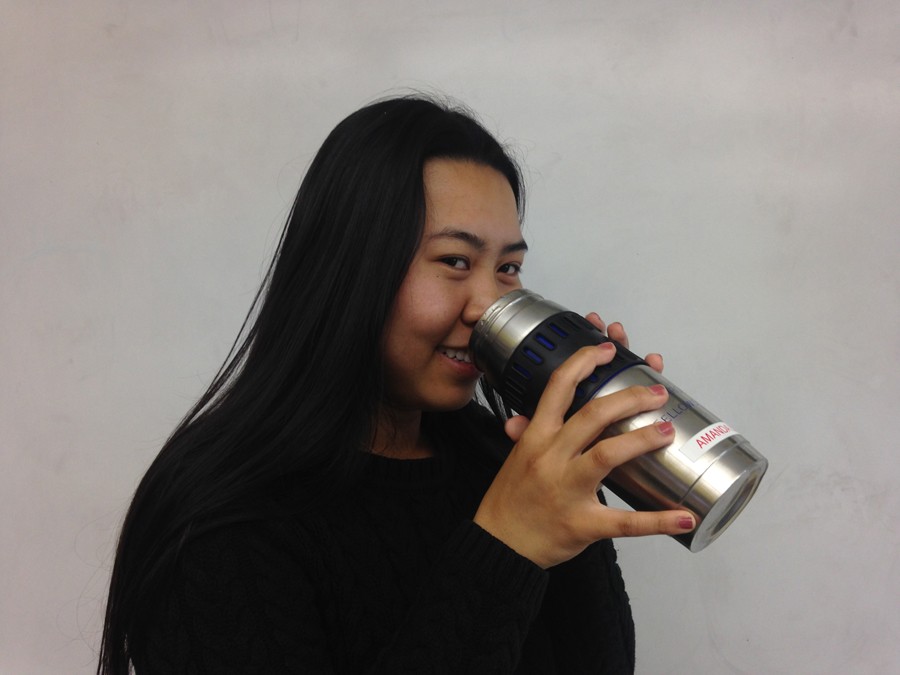 Senior Amanda Leutmixay prepares to drink out of her thermos of tea. 