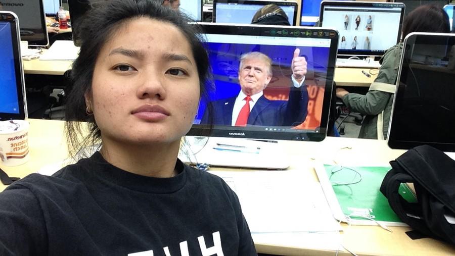 Senior+Copy+Editor+Jessica+Ong+poses+in+front+of+a+Donald+Trump+Photo.