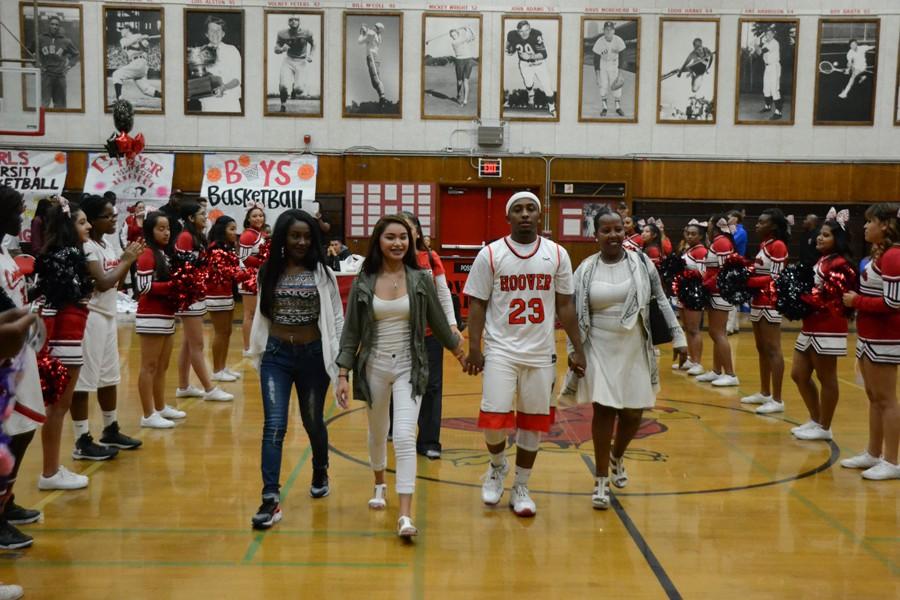 Senior Tracy Evans walks with his family and friends on Senior Night. 