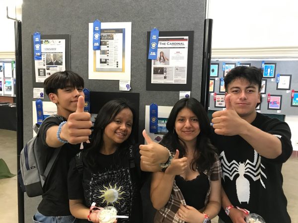 Staff writer Oliver Almeida 25, Junior Editors Natalie Molina 25 and Alejandra Ramirez 25, and Associate Editor Jesus Gastelum 23, pose in front of The Cardinal First Place win.